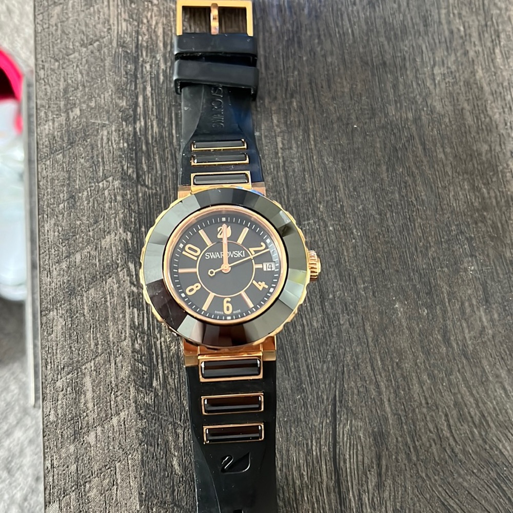 Black and gold Swarovski watch